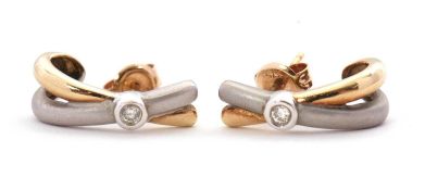 A pair of 9ct bi-colour gold and diamond earrings, the crossover earrings with satin finish yellow