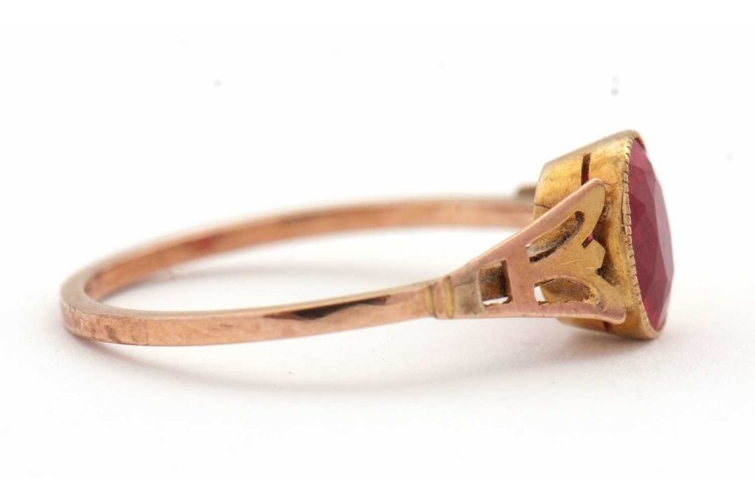 A synthetic ruby ring, the oval synthetic ruby with tapered shoulders and plain band stamped 9ct, - Image 5 of 8