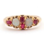 An opal and ruby ring, wtih two round opal cabochons and small round faceted rubies, with tapered
