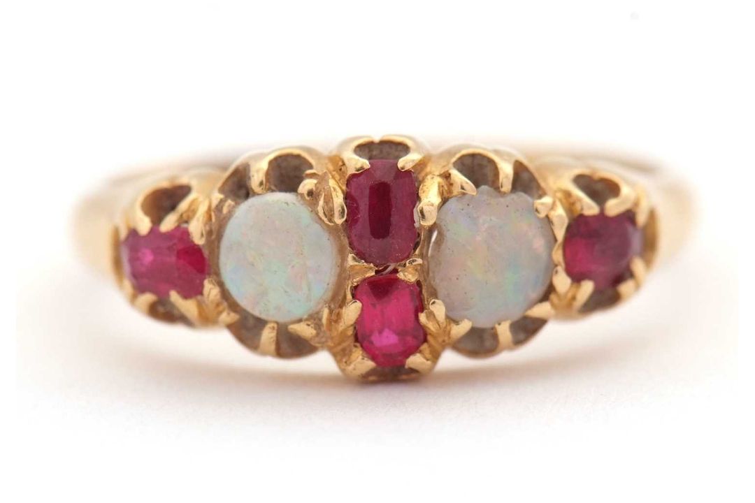An opal and ruby ring, wtih two round opal cabochons and small round faceted rubies, with tapered - Image 1 of 6