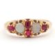 An opal and ruby ring, wtih two round opal cabochons and small round faceted rubies, with tapered - Image 1 of 6