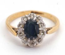 A sapphire and diamond ring, the oval sapphire surrounded by single cut diamonds, with plain band