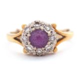 An 18ct amethyst and diamond ring, the central round amethyst surrounded by single cut diamonds,