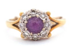An 18ct amethyst and diamond ring, the central round amethyst surrounded by single cut diamonds,