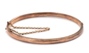 A 9ct gold bangle, 4mm wide, stamped 9.375 and hallmarked Birmingham 1912, inner diameter 56mm, 8.