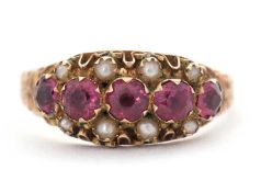 A late Victorain 9ct garnet and seed pearl ring, with five round garnets and seed pearls above and