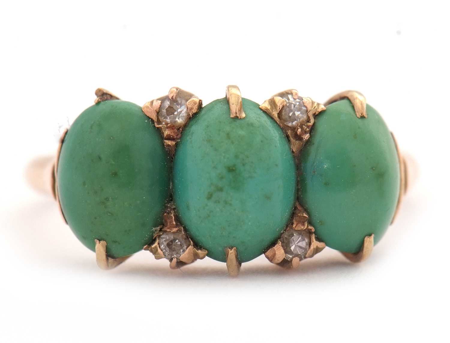 A turquoise and diamond ring, the three oval turquoise cabochons with diamond highlights, all set in