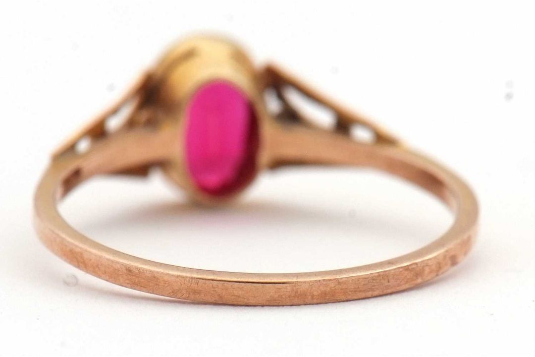 A synthetic ruby ring, the oval synthetic ruby with tapered shoulders and plain band stamped 9ct, - Image 8 of 8