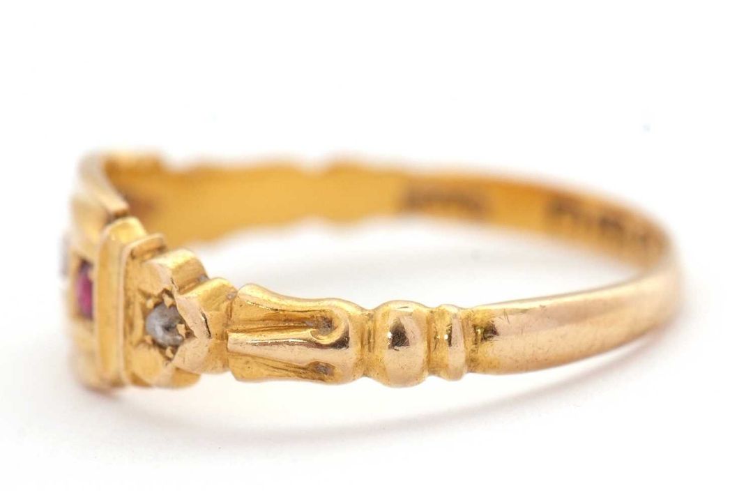 An Edwardian 18ct ruby and diamond ring, set with a central round diamond and a round ruby to either - Image 5 of 7