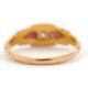 An Edwardian 18ct ruby and diamond ring, set with a central round diamond and a round ruby to either - Image 6 of 7