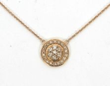 A 9ct Argyle champagne diamond pendant, the round disc set with round brilliant cut Argyle champagne