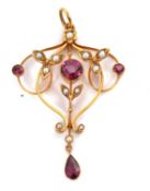 An Edwardian garnet and seed pearl pendant, the openwork pendant set to centre with a round garnet