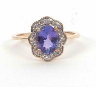 A 9ct tanzanite and white sapphire ring, the oval tanzanite surrouned by small round white