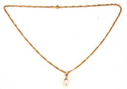 A 21K necklace and cultured pearl pendant, the cultured pearl pendant with unmarked tapered cap