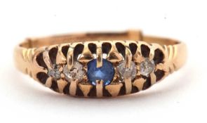 A sapphire and diamond ring, the central round sapphire with two graduated old mine cut diamonds