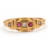 An Edwardian 18ct ruby and diamond ring, set with a central round diamond and a round ruby to either