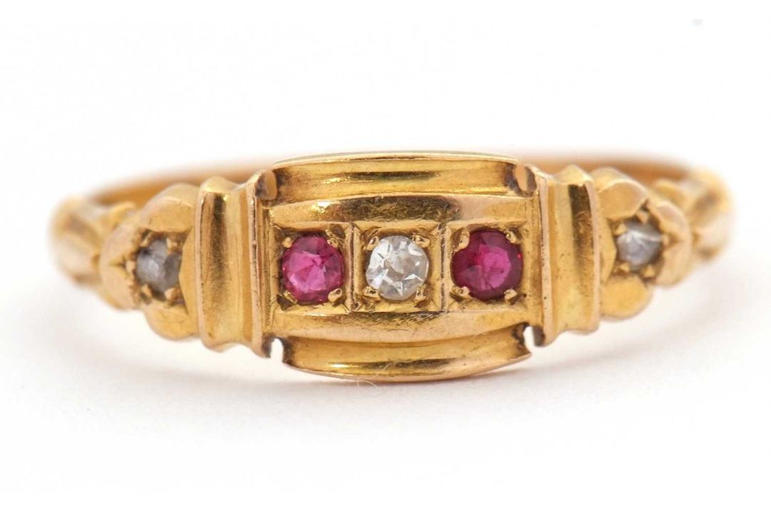 An Edwardian 18ct ruby and diamond ring, set with a central round diamond and a round ruby to either - Image 1 of 7