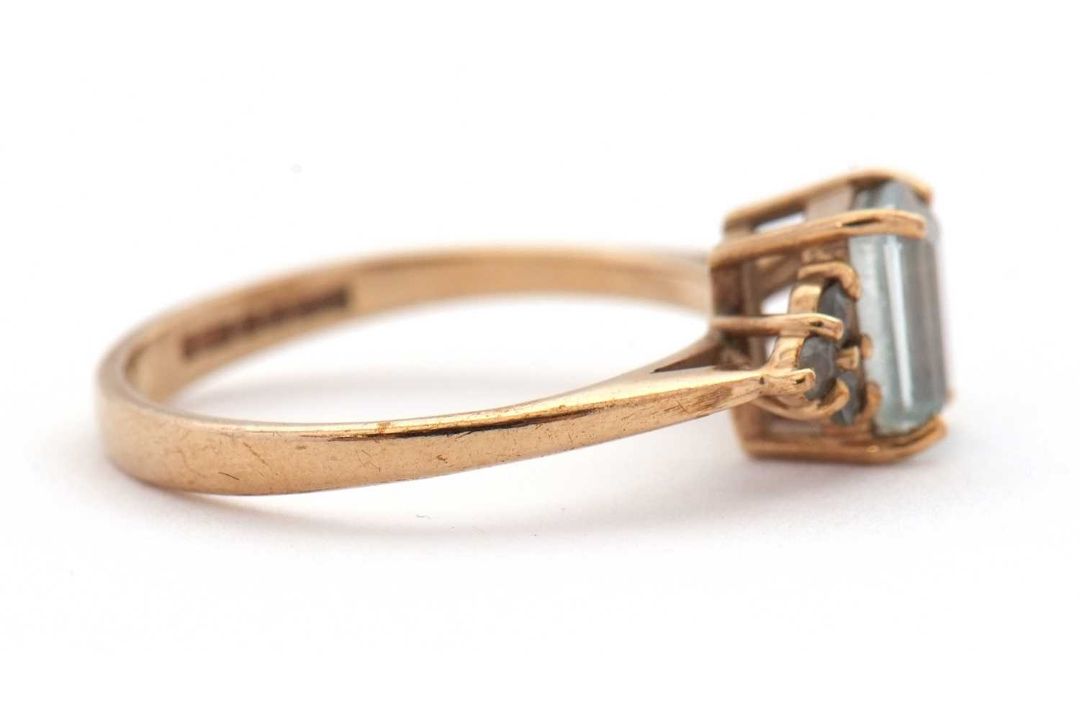 A 9ct aquamarine ring, set with an emerald cut aquamarine and three small round aquamarines to - Image 6 of 8