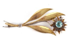 A modernist silver, silver gilt and topaz flower brooch, the flowerhead set to centre with a blue