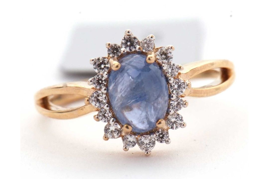 A 9ct sapphire and white zircon ring, the central oval sapphire cabochone, surrounded by small round - Image 4 of 6