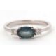 A 9ct sapphire and diamond ring, the oval blue-green sapphire set to either side with a round - Image 7 of 8