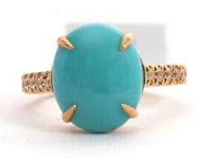 A 9ct turquoise and white zircon ring, the oval turquoise cabochon, with half set white zircon