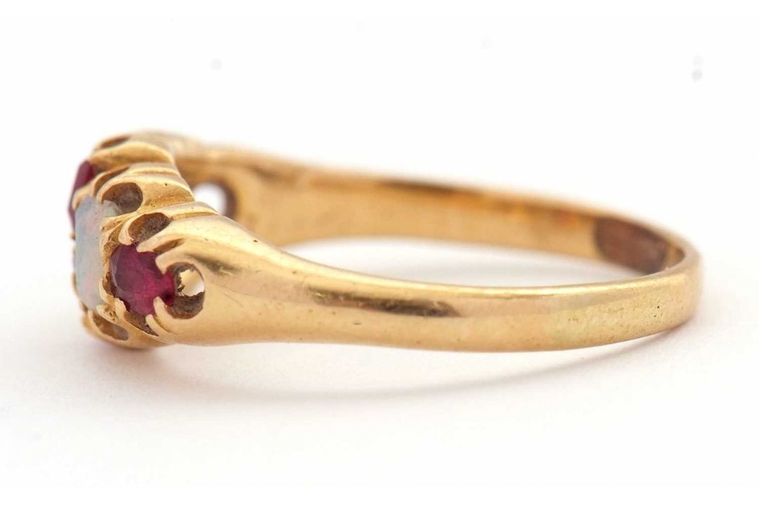 An opal and ruby ring, wtih two round opal cabochons and small round faceted rubies, with tapered - Image 5 of 6