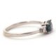 A 9ct sapphire and diamond ring, the oval blue-green sapphire set to either side with a round - Image 2 of 8
