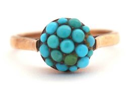 A turquoise cluster ring, the cluster composed of small turquoise cabochons, in raised mount with