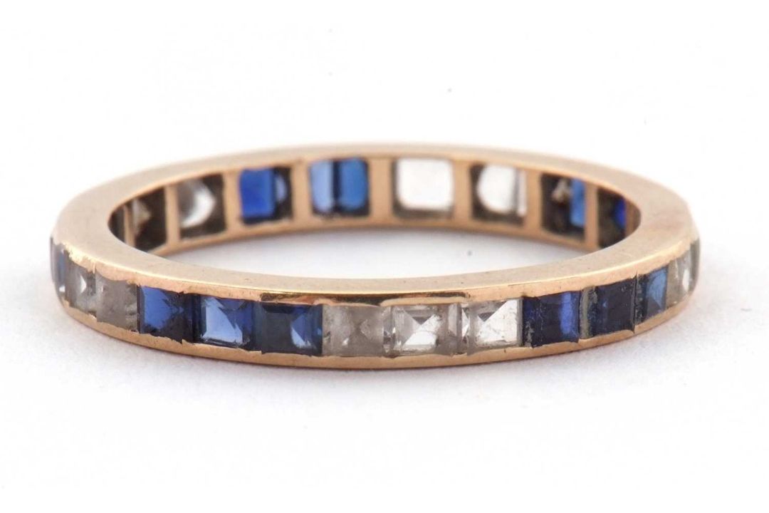 A blue and white stone eternity ring, the full hoop ring with channel set with blue and white - Image 2 of 3