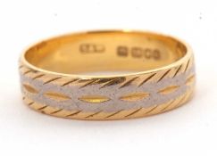 An 18ct gold ring, 4.5mm wide, with engraved decoration, hallmarked London 1963, size M-N, 3.4g