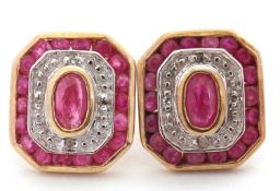 A pair of 9ct ruby and diamond earrings, with a central collet mounted oval ruby surrounded by