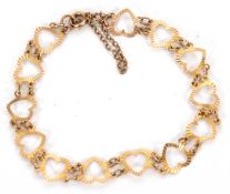 A 9ct heart bracelet, the heart shape links stamped 375 to last link with London assay mark (year