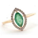 An emerald and diamond ring, the marquise emerald within an open frame of small round diamonds,