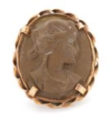 A lava cameo ring, the oval lava cameo carved with the head of a lady, claw mounted with rope