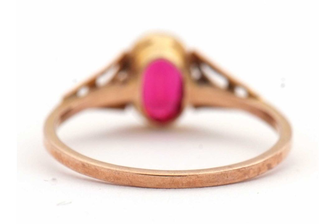 A synthetic ruby ring, the oval synthetic ruby with tapered shoulders and plain band stamped 9ct, - Image 4 of 8