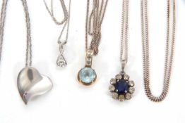 Four necklaces: to include a 9ct CZ pendant and chain stamped 375, 1.4g; a 9ct topaz and white stone