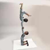 A CONTEMPORARY BRONZE SCULPTURE OF TWO BOYS PLAYING.