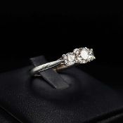 AN 18CT WHITE GOLD DIAMOND TRILOGY RING.