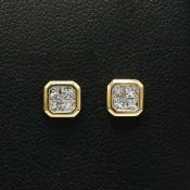 A PAIR OF 18CT GOLD DIAMOND SET STUD EARRINGS.