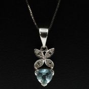 A TOPAZ AND DIAMOND 9CT WHITE GOLD PENDANT.