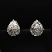 A PAIR OF DIAMOND ENCRUSTED 9CT WHITE GOLD EARRINGS.