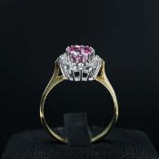 A 9CT GOLD TOPAZ AND DIAMOND DRESS RING.