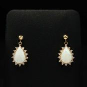 A PAIR OF 14CT GOLD OPAL SET EARRINGS.