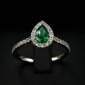 AN 18CT WHITE GOLD EMERALD AND DIAMOND RING.