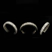 A WHITE METAL DIAMOND ETERNITY RING.