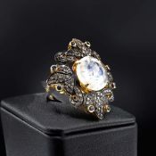 A DIAMOND, MOONSTONE AND SAPPHIRE DRESS RING.