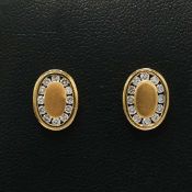 A PAIR OF 18CT GOLD DIAMOND SET STUD EARRINGS.