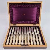 A WALKER AND HALL SET OF SILVER AND MOTHER-OF-PEARL HANDLED FRUIT KNIVES AND FORKS.