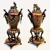 PAIR OF JAPANESE BRONZE LIDDED URNS ON STANDS.
